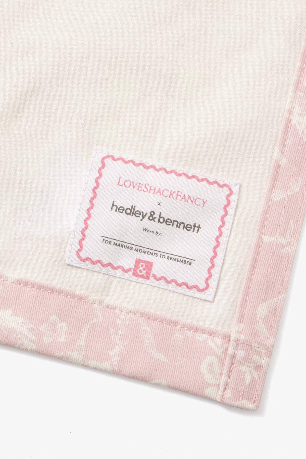 Brand label on pink apron hem: LoveShackFancy Hedley & Bennett &