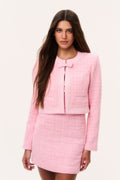 Pink tweed jacket with pearl trim, zip front, and flap pockets