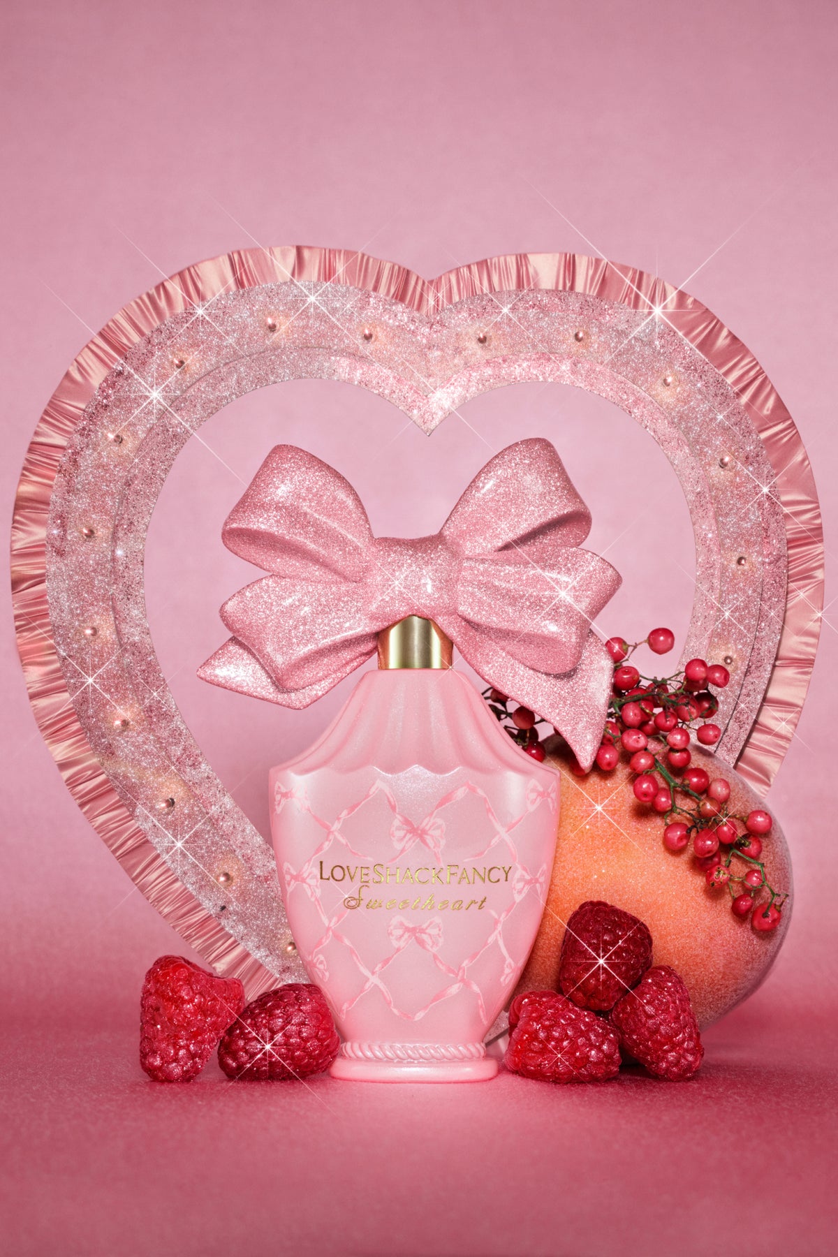 Pink hair and body perfume mist bottle with glitter bow and decorative heart stand