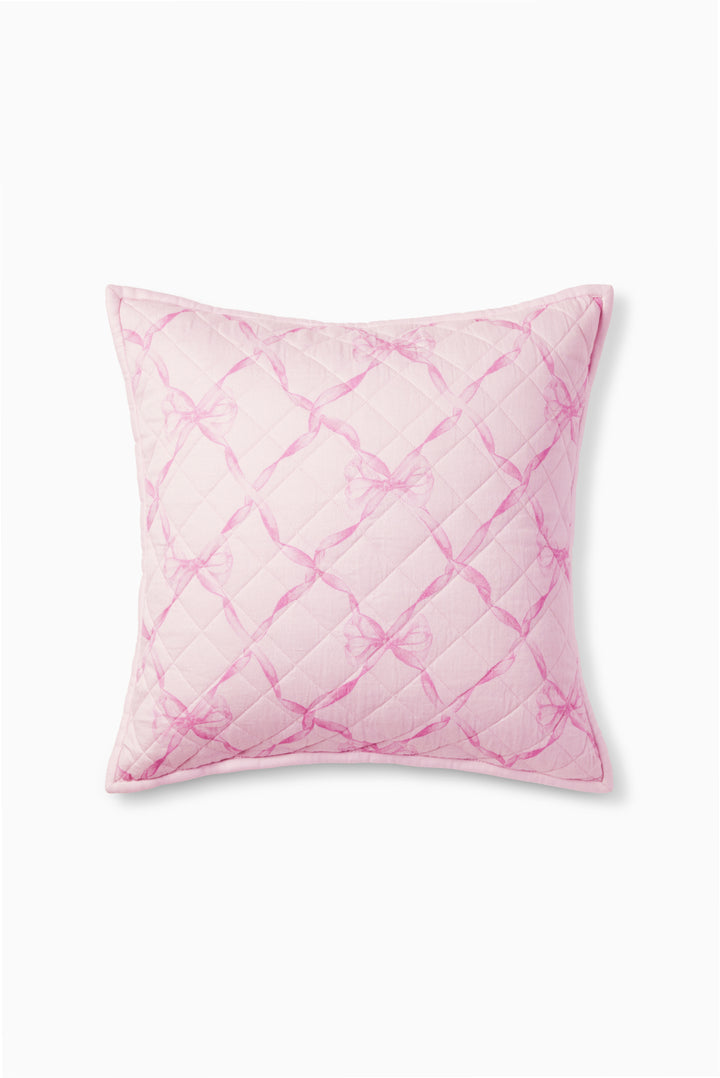 Pink quilted throw pillow with diamond lattice pattern and piped edges