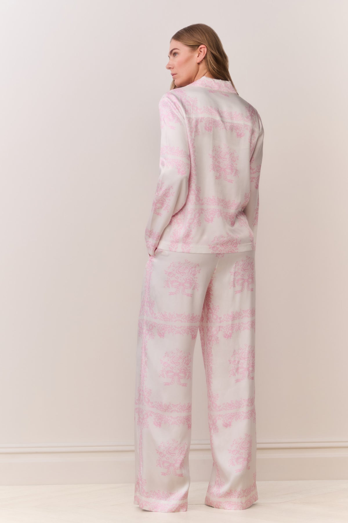 Back view of long-sleeve ivory shirt with pink bandana toile print and button front