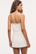 Ivory tweed mini skirt on model, back view with straight hem and seam line