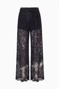 Black sheer lace wide-leg pants with tied waist and scalloped hem edge.
