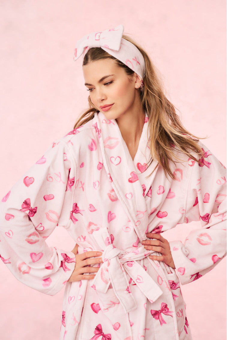 Pink patterned bow headband with fabric knot front, elastic back