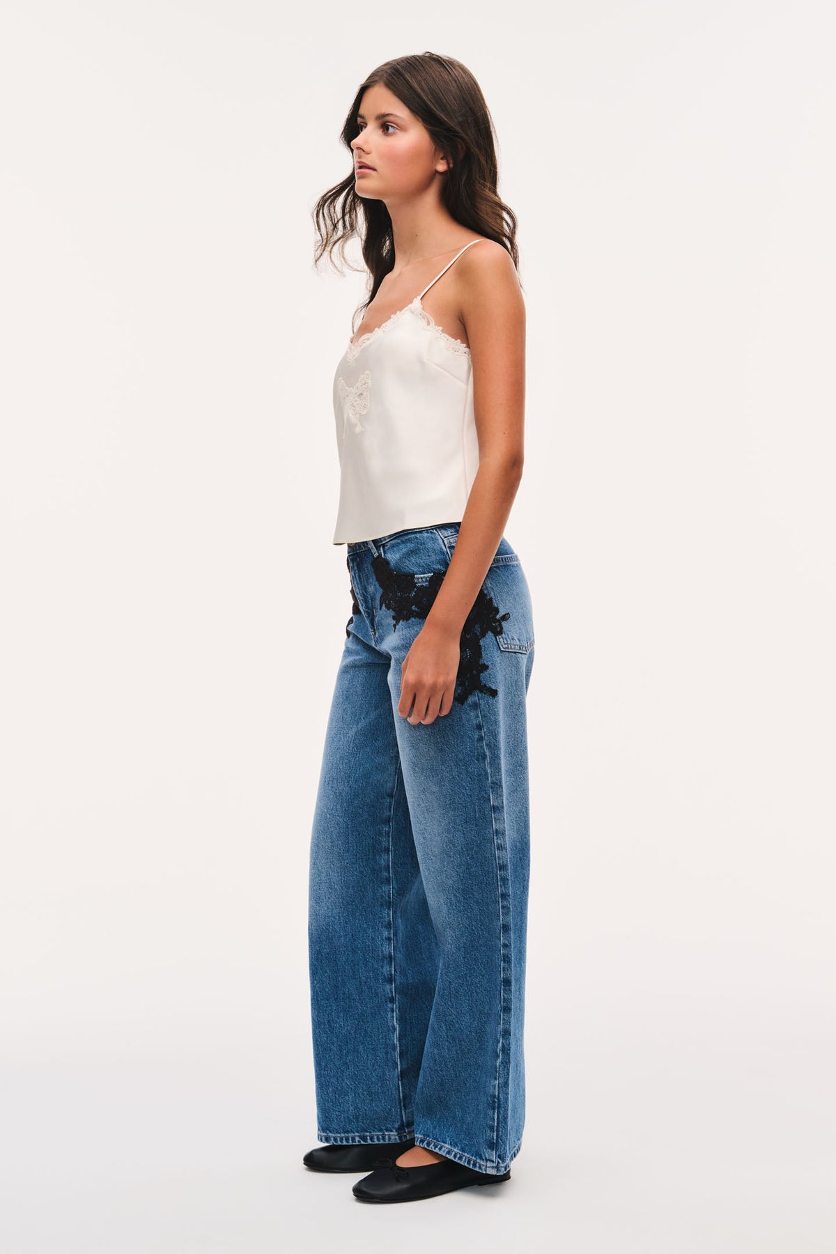 Wide-leg indigo jeans with black lace appliqué and high waist