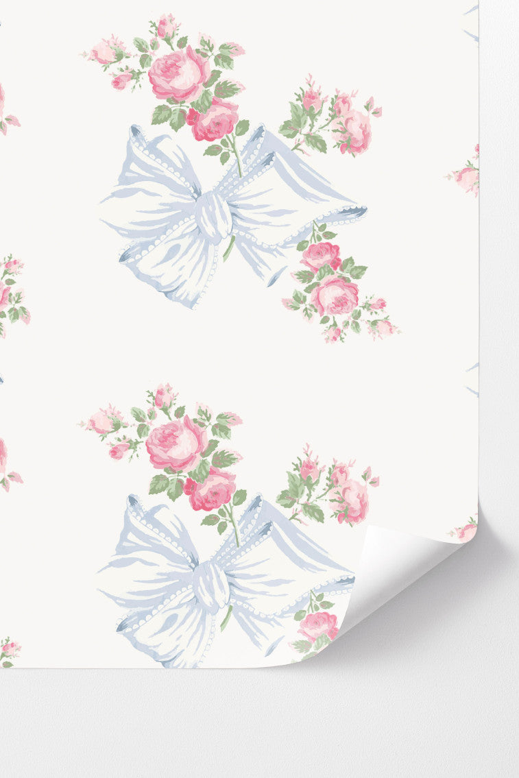Peel-and-stick wallpaper with pastel blue ribbon bows and pink rose pattern