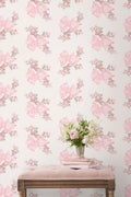 Peel-and-stick wallpaper pattern of pink bows, roses, and mint-green leaves on wall