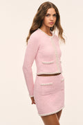 Pink knit tweed mini skirt with contrast trim and patch-pocket style details