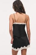 Black crepe mini skirt with white lace hem and bow appliques (back view)