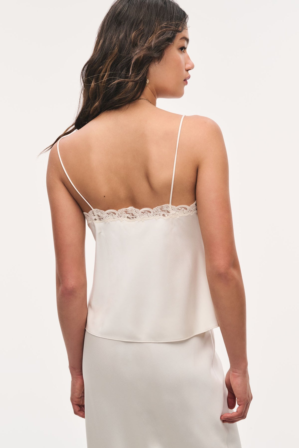 Alabaster crepe lace cami with spaghetti straps and scalloped lace back neckline.