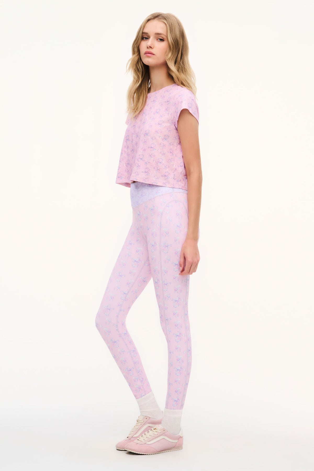 Light mauve mixed-print leggings, full-length, worn in side profile