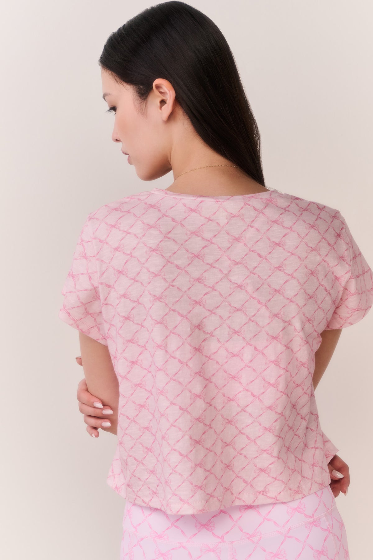 Pink cropped tee with lattice texture, short sleeves, and back view