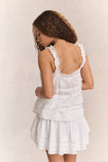 White tiered ruffle mini skirt from back view with stacked flounce layers