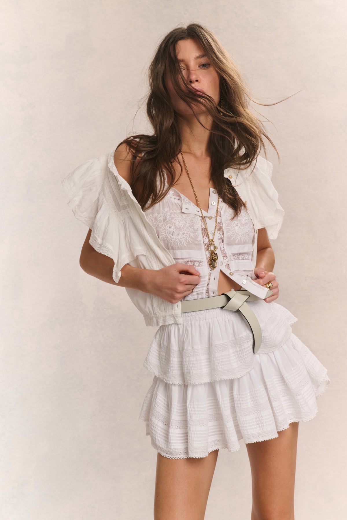White tiered ruffle mini skirt with layered tiers and flounce hem