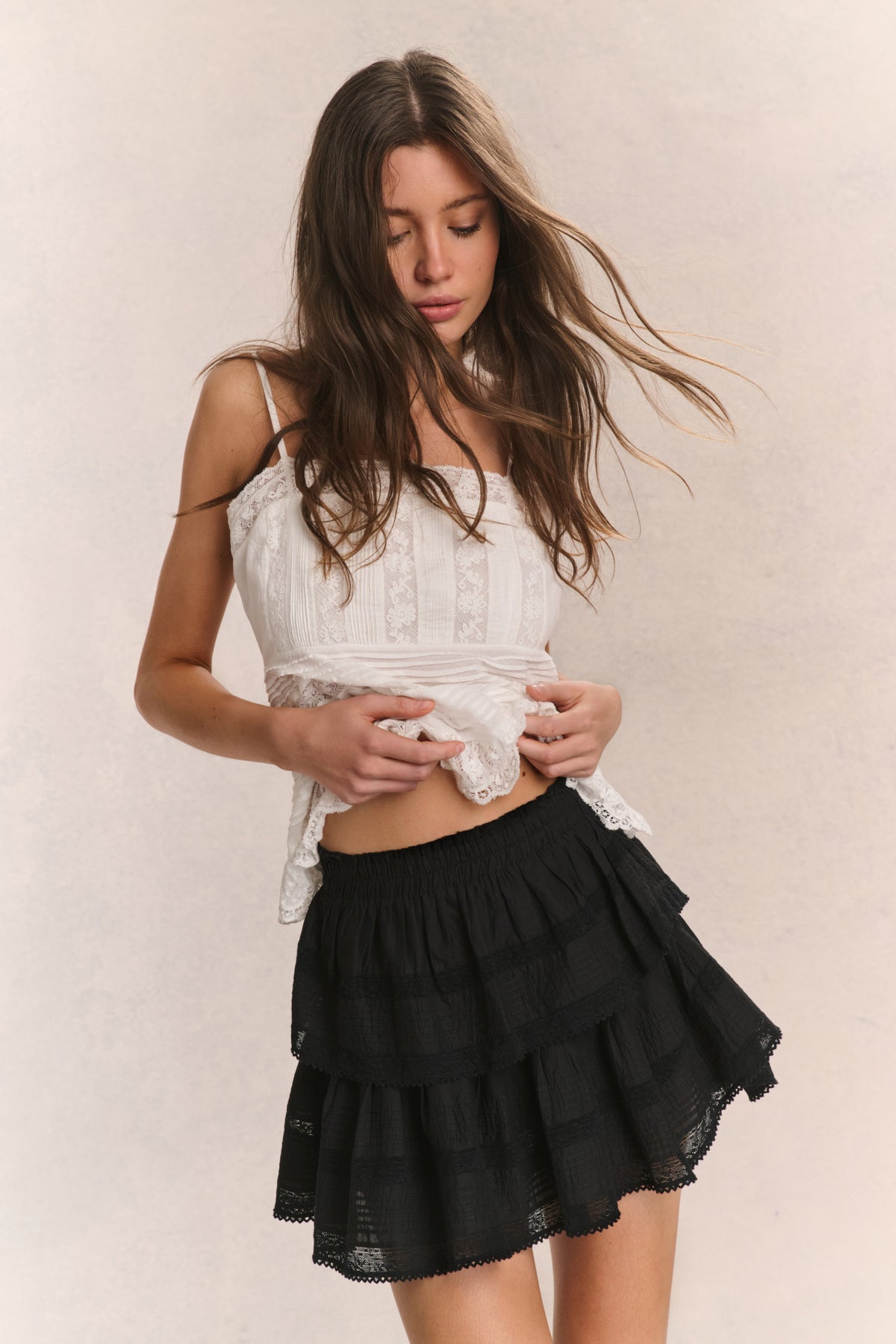 Black tiered ruffle mini skirt with gathered waist and layered flounce tiers