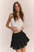 Black tiered ruffle mini skirt with layered tiers and gathered waist