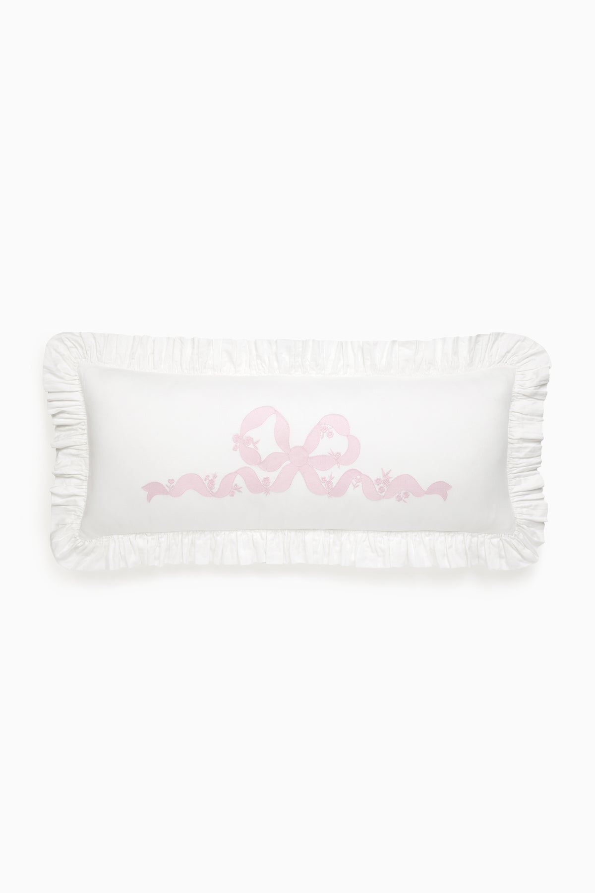 White lumbar pillow with pink embroidered love motif and ruffled edges