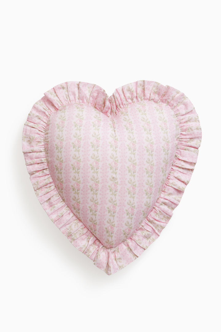 Heart-shaped ruffle pillow in pink floral fabric with gathered edge