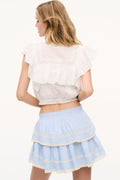 Chambray blue cotton ruffle mini skirt with tiered layers and gathered waistband