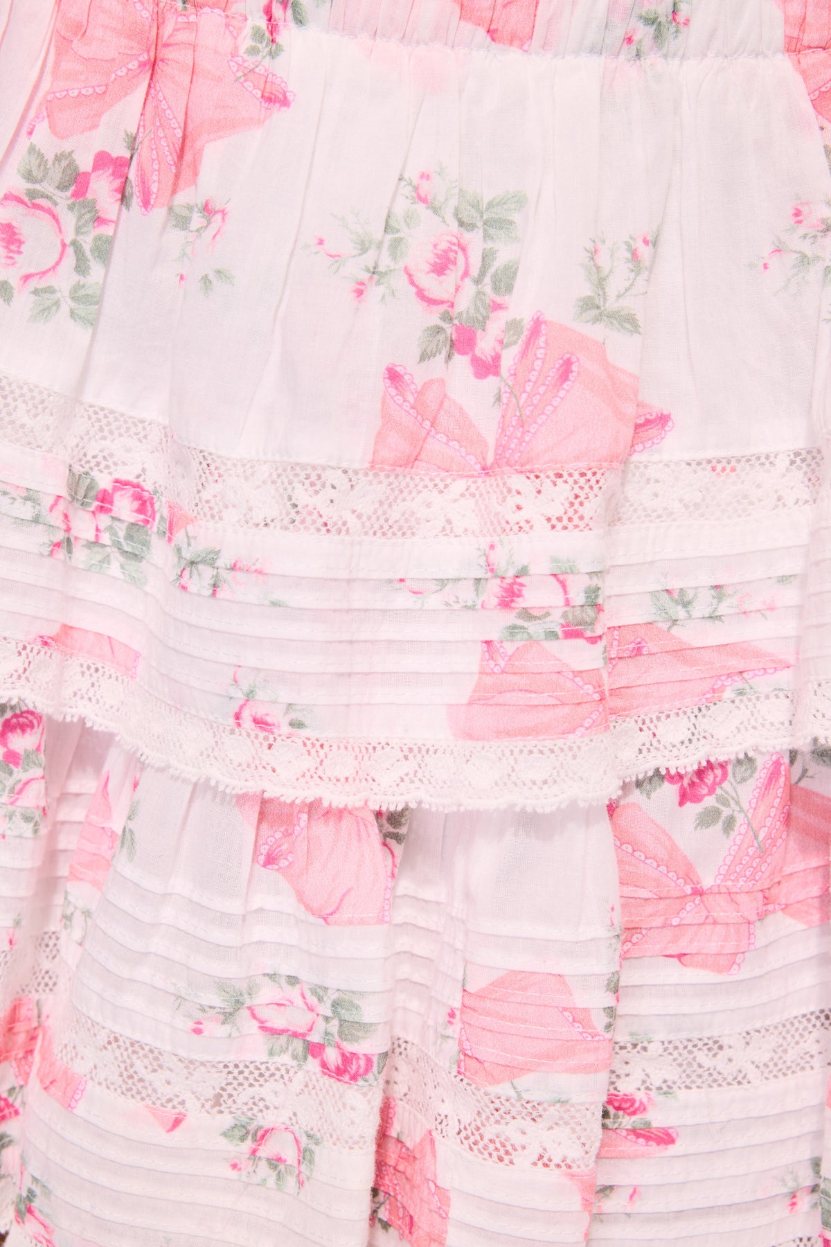 Floral print tiered ruffle mini skirt with pink accents on white