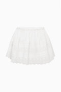 White cotton Victorian mini skirt on mannequin; tiered ruffles and lace-trim hem