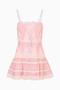 Pink lace mini dress with thin spaghetti straps and tiered ruffle hem