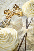 Cream decorative perfume bottle with gold bow and floral wrap design