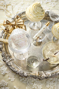 Eau de parfum bottle on an ornate tray with gold bow and glass accents