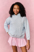 Pink gingham skort with elastic waistband and flared pleated hem, under a hoodie