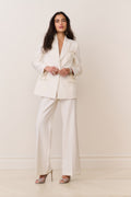 Cream wool-blend blazer with satin bow accents at cuffs and flap pockets, front view