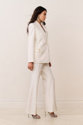 Cream wide-leg trousers with front crease and side-seam pockets