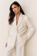Cream wool-blend blazer with satin bows at chest and flap pockets, front button closure