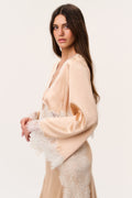 Silk-blend top with lace cuffs and hem; long sleeves in pale gold tone