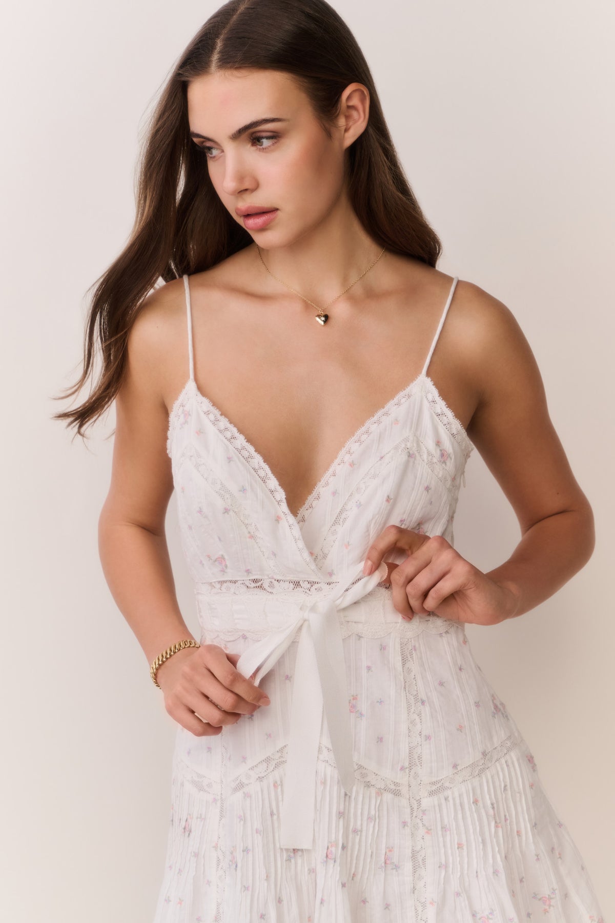 White floral embroidered cotton mini dress with V-neck, lace trim, and waist tie