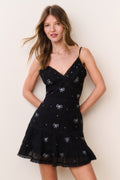 Black cotton mini dress with V-neck and spaghetti straps, crystal bow motifs, flared hem