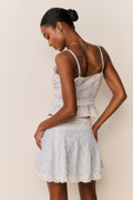 Floral cotton mini skirt with white base, gathered tiers and lace hem