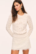 Off-white lace mini skirt with textured knit pattern and scalloped lace edge