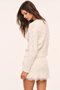 Off-white lace mini skirt with scalloped hem, back view