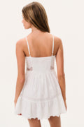 White cotton lace mini dress, back view with thin spaghetti straps