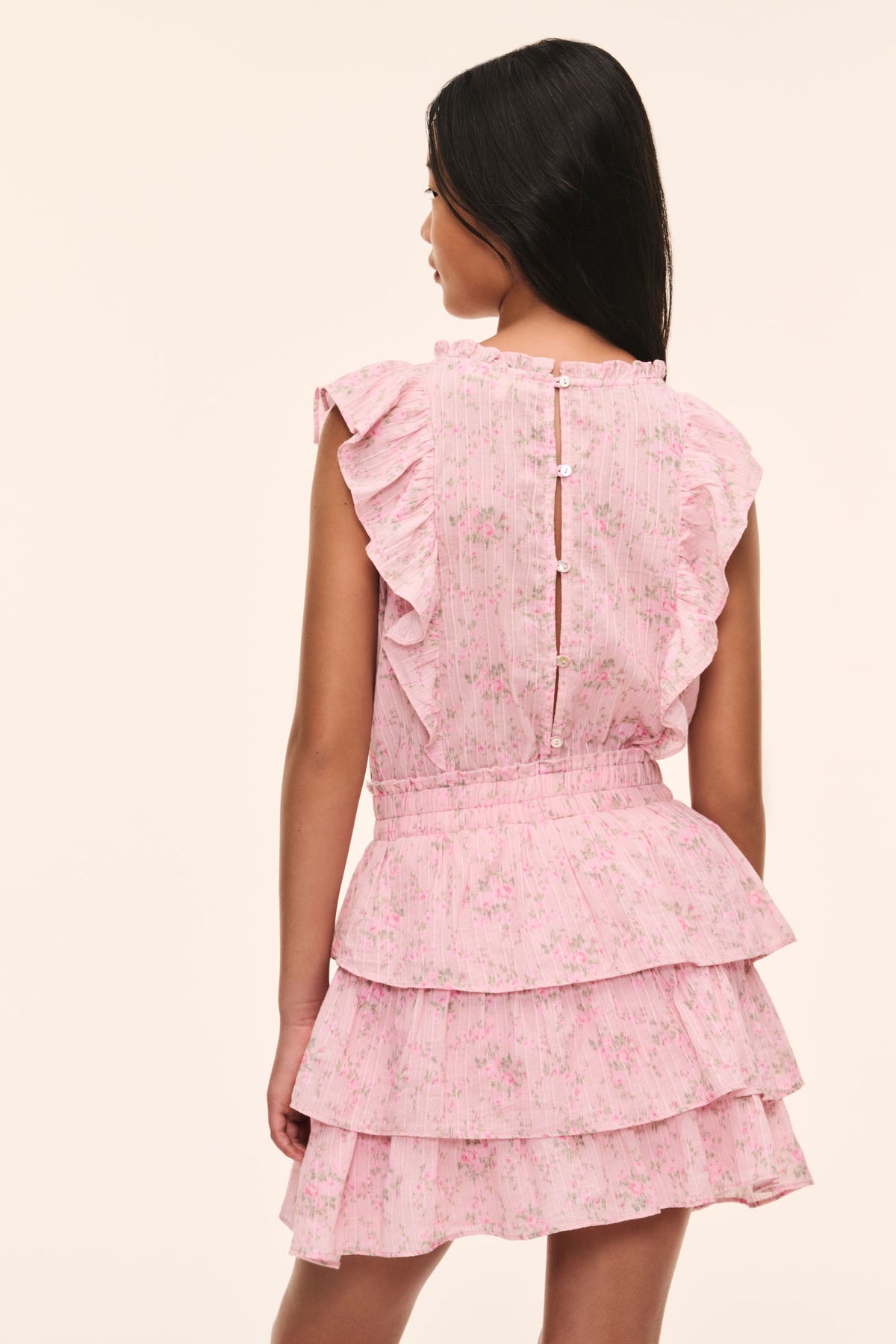 Girls pink floral tiered ruffle dress with back button placket, short flutter sleeves.