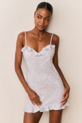 Floral cotton mini dress with thin straps, ruffle trim bodice, and short hem