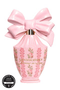 Pink eau de parfum bottle with oversized satin bow and floral label
