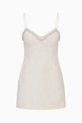 Ivory tweed mini dress on white background with spaghetti straps and lace trim