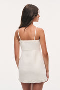Ivory tweed slip dress back view with thin straps and beaded hem trim