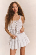 White cotton camisole top with lace straps, button front, and layered ruffle skirt