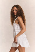 White cotton camisole top with lace-trim straps and button front, side view