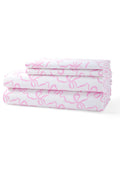 Printed cotton sheet set with pink bow pattern, neatly folded