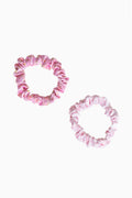 Two pink satin scrunchies with gathered ruffled texture