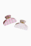 Two small pink floral claw clips with scalloped fabric bows