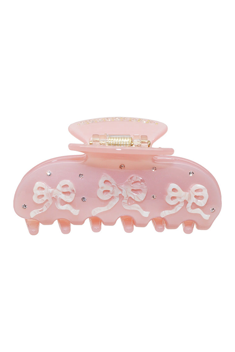 Pink translucent pixie claw clip with bow-like ribbon accents